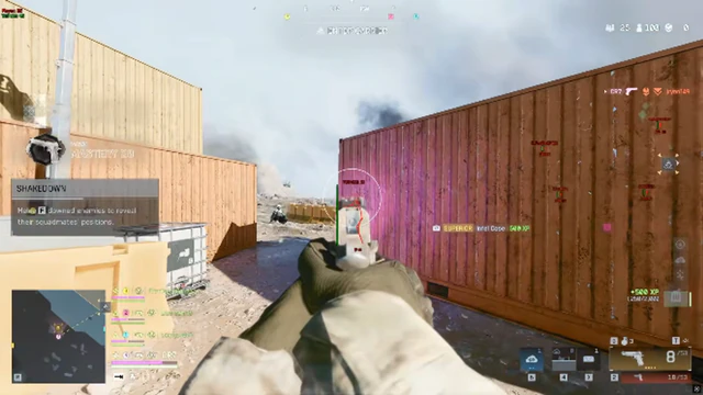 Battlefield 6 shipping-container alley with a catch-the-cargo objective and pistol crosshair.