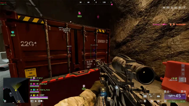 Battlefield 6 cave tunnel scene with a scoped assault rifle pointed at a red shipping container.